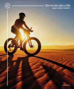 Number 9 magazine cover with kate leeming cycling on sand
