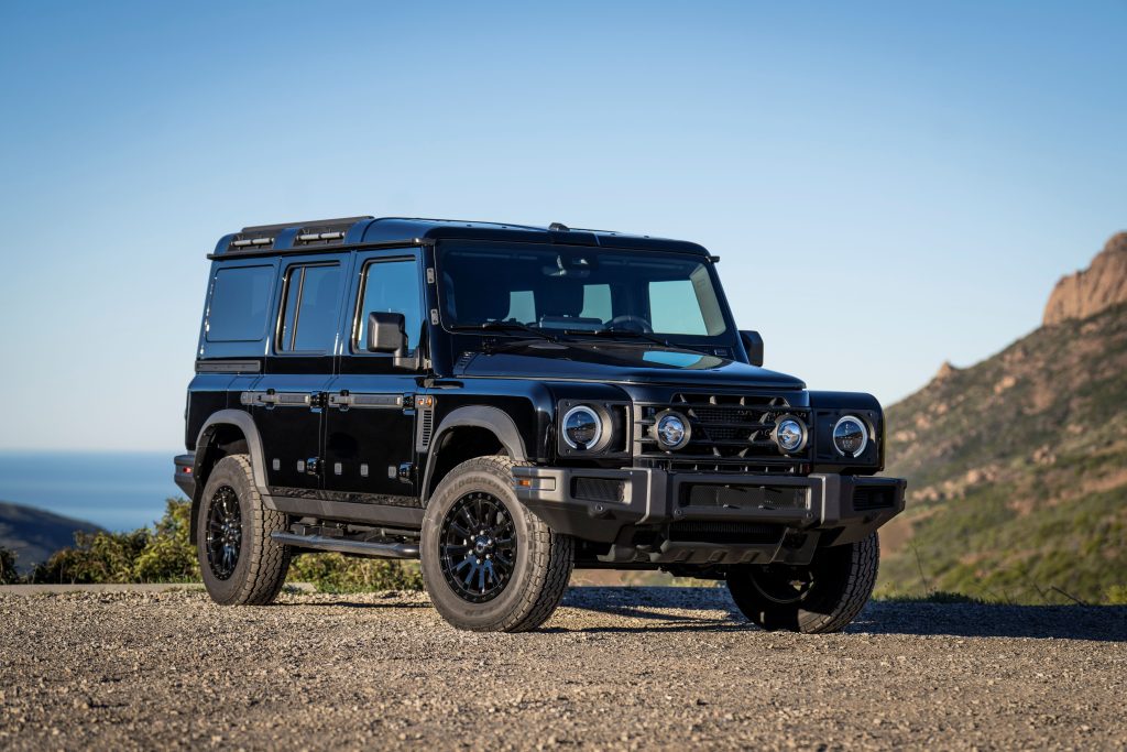 Ineos Grenadier Black Edition standing off pavement near a hill