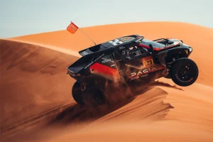 dacia Sandrider cresting a dune