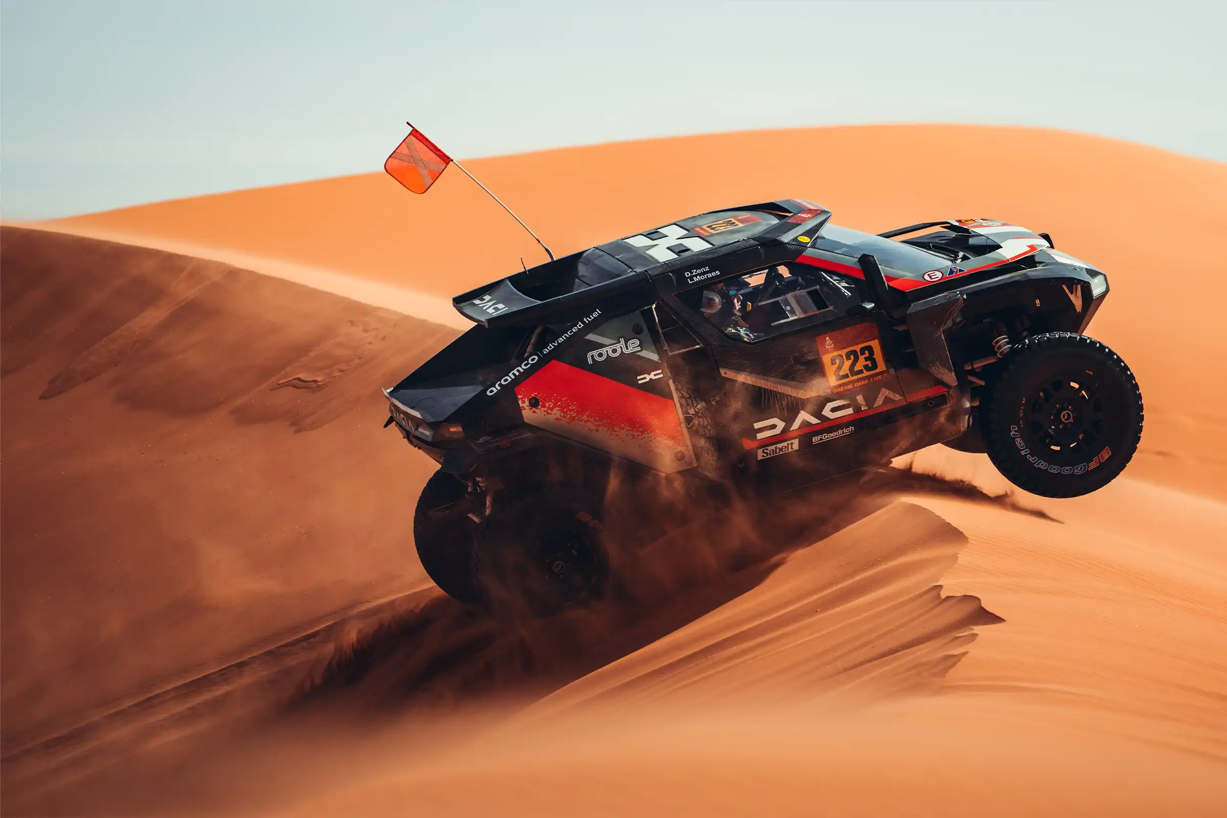 dacia Sandrider cresting a dune