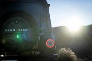 Ineos grenadier spare rear with hills and sunset in the background