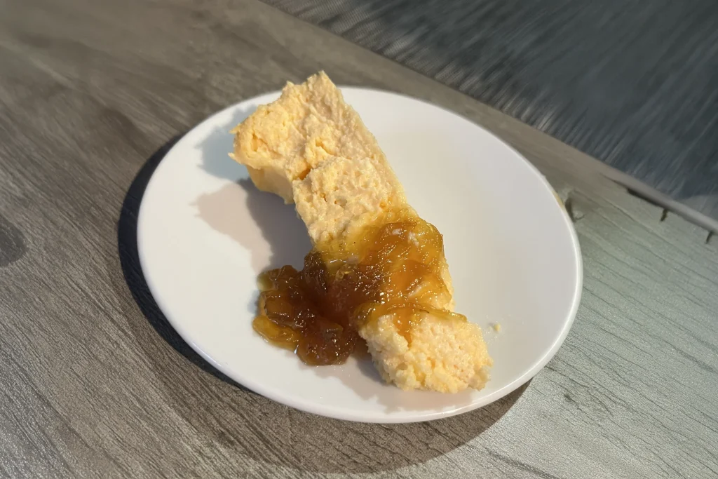 a slice of capmany cheesecake with jam