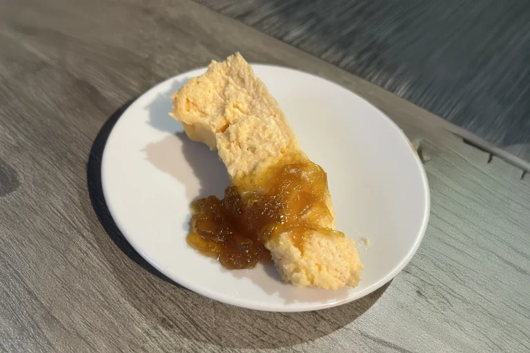 a slice of capmany cheesecake with jam