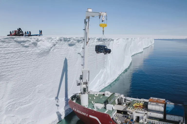 ineos grendier being lifted from the boat onto the ice shelf in antarctica