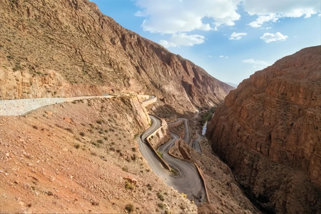 Mountain road winding through the steep rock walls of the Dadès Gorge in Morocco.