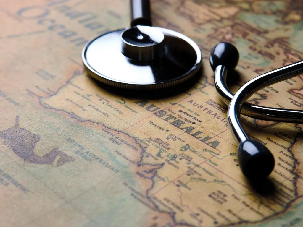 world map with a stethoscope lying on it