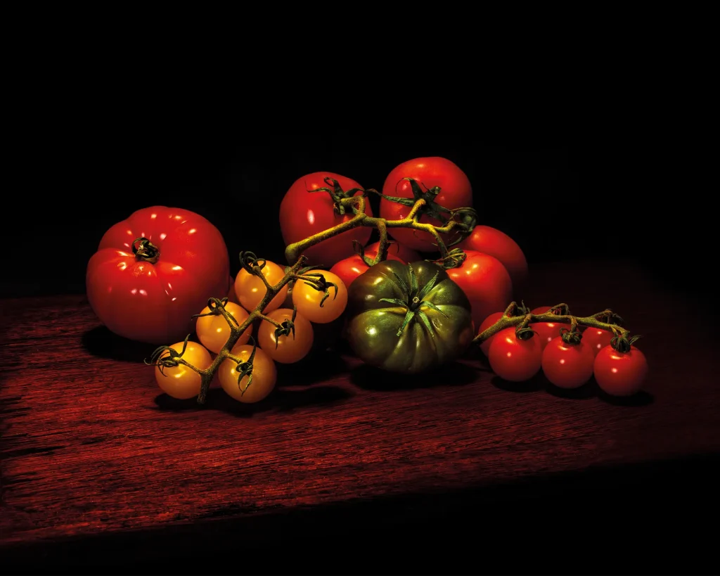 different kinds of tomatoes on a wooden board