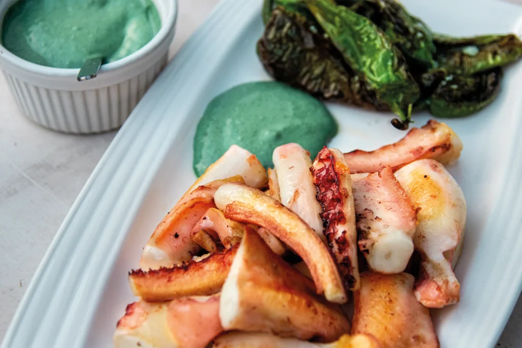 Grilled octopus served with Padrón peppers and green spirulina aioli.