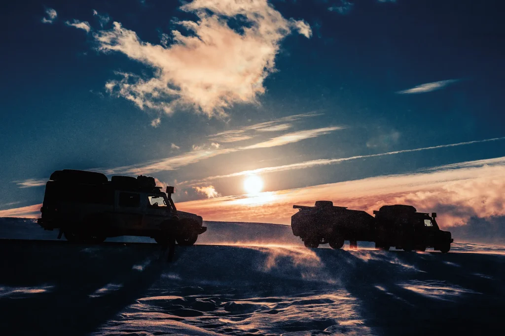 Two expedition Grenadiers silhouetted against the low Arctic sun during a reconnaissance trip to Nordkapp before the Cape-to-Cape record attempt.
