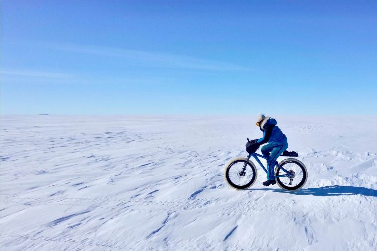 Kate Leeming riding on her bicycle across Queen Maud Land, Antarctica